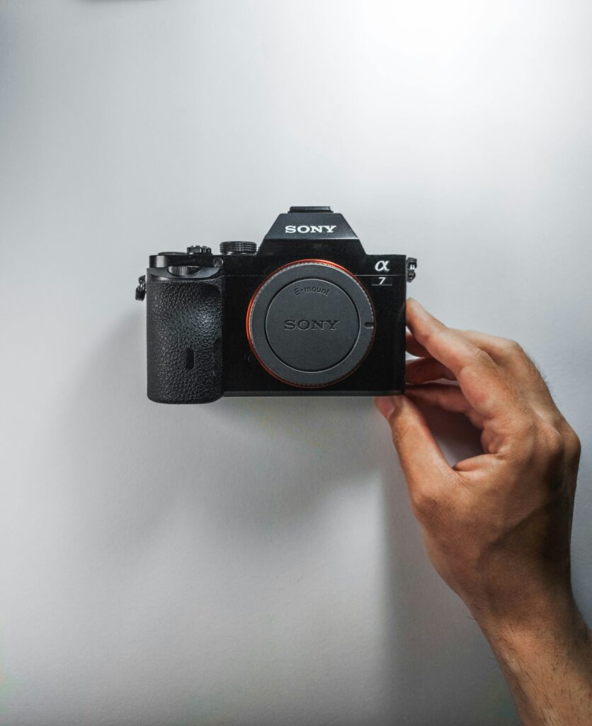 person holding black nikon dslr camera